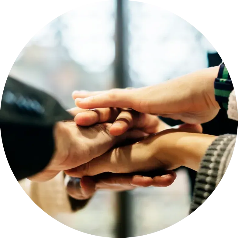 Multiple hands joined together in collaboration